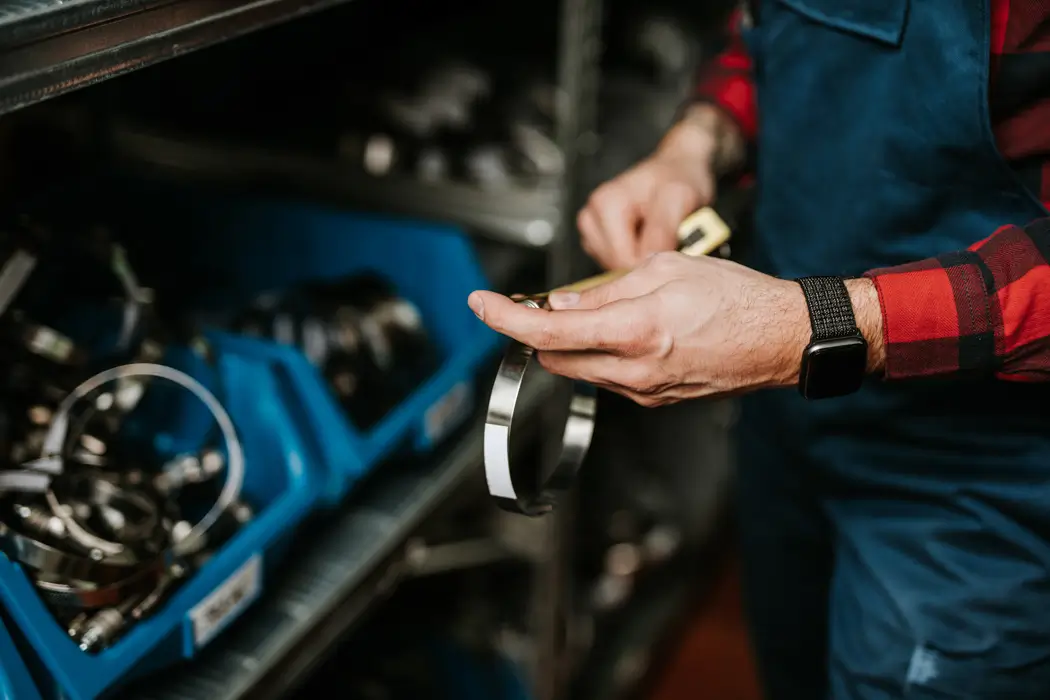 Parts Employee Holding Parts in Warehouse